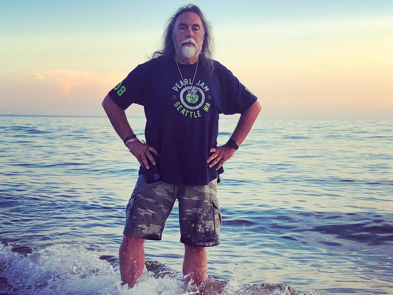 Warren Wyatt standing in the surf at sunset